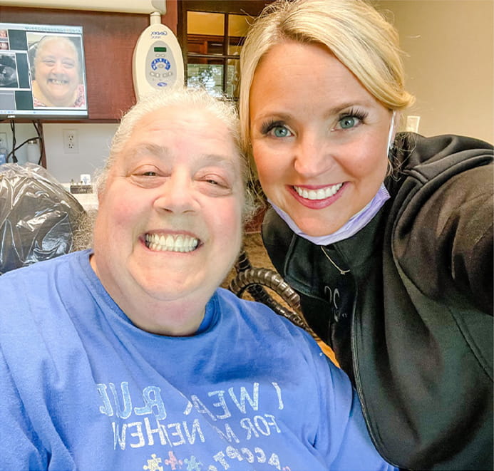 Services2_03-min Dentist smiling with patient